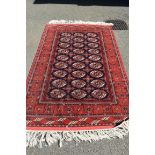 A Persian rug, having repeated medallion design to centre on a blue ground, having floral and