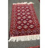 A Persian rug having allover geometric design and floral border, 150 x 90cm.