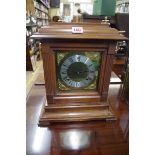 A walnut mantel clock, 35cm high, with pendulum.