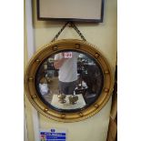 A small gilt framed convex mirror, 39.5cm wide.