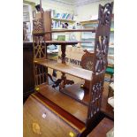 An Edwardian mahogany three tier hanging wall shelf, 62cm wide.