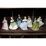 Seven Royal Doulton figures, comprising 'Rendezvous', HN2212; 'Soiree', HN2312; 'Enchantment',