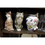 A pottery tabby cat, by Jenny Winstanley, 28.5cm high; together with another pottery cat; and a