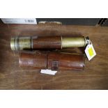 An old brass and leather three drawer telescope, 40cm extended, with leather case.