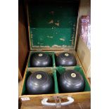 An oak cased set of four 'Jaques & Son' bowls.