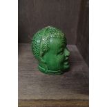 A novelty green glazed pottery head moneybox, 8.5cm high.