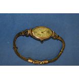 An Etna 9ct gold ladies wristwatch, on rolled gold bracelet, import mark London 1927.