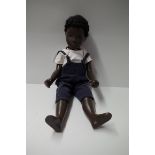 A vintage Sasha doll, 'Caleb' in blue cord dungarees and white shirt.