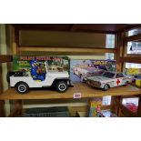 A vintage Made in Japan battery operated tinplate Police Patrol Jeep; together with a similar
