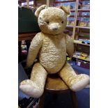 A vintage large golden mohair teddy bear, approx 29cm long; together with another smaller plush