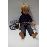 A vintage Sasha doll, blonde 'Gregor', in blue knitted jumper and jeans, with associated jacket.