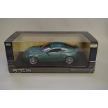 A Hot Wheels 1/18 scale Aston Martin V8 Vantage, green, in box.