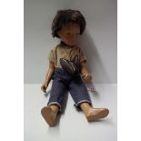 A vintage Sasha doll, brunette 'Gregor', in blue jeans and beige cord shirt, brown leather shoes.