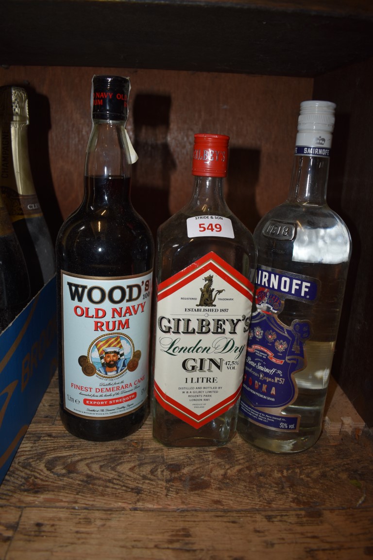 A 1 litre bottle of Wood's Old Navy rum; together with a 1 litre bottle of Gilbey's gin; and a 1