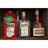Three bottles of orange liqueur, comprising: two 70cl Cointreau, one in velvet draw string bag;