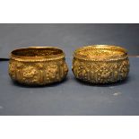 A pair of Burmese white metal bowls, decorated panels of animals.