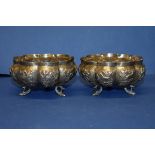 A pair of Indian white metal footed bowls, decorated animals.