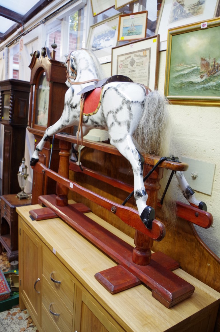 An old dappled grey rocking horse.