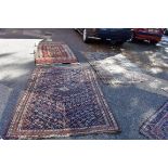 An old Persian rug, having allover geometric design; together with a similar Persian rug having