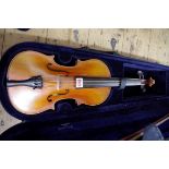 An antique Continental violin, with single piece 14in back, with bow and padded case.