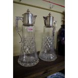 A pair of electroplate mounted clear glass claret jugs, 32cm high.