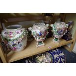 A pair of Continental porcelain jars and covers, painted with panels of figures, 32cm high, (the