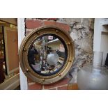 A reproduction gilt framed circular convex wall mirror, 42cm diameter.