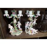A pair of Continental porcelain figural three branch candelabra, 29.5cm high.