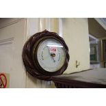 An old oak ropetwist aneroid barometer.
