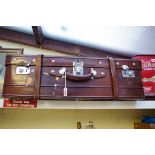 A vintage brown leather suitcase, 83cm wide.