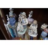 Four Lladro figures; together with three similar Nao figures.