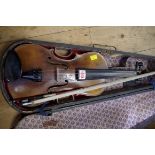 An antique Continental violin, with 14in back, with ebonized wood case and bow.