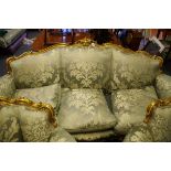 A good Louis XV style carved giltwood and silk damask three seater settee, feather stuffed, 208cm