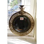 A cast brass framed circular wall mirror, 24.5cm diameter.