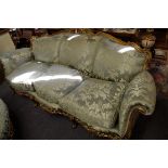 A good Louis XV style carved giltwood and silk damask three seater settee, feather stuffed, 208cm