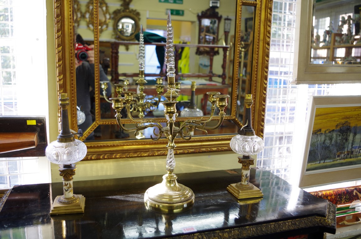 A pair of small brass and glass table lamps; together with another brass six branch candelabrum,