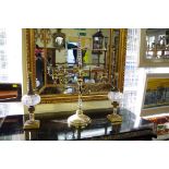 A pair of small brass and glass table lamps; together with another brass six branch candelabrum,