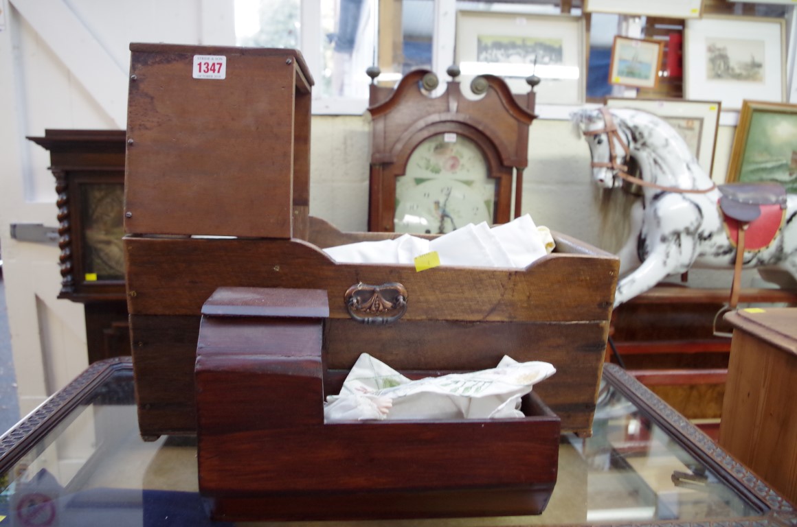 An old doll's crib; together with another similar smaller example, with bisque head.