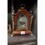 A small 18th century style walnut mantel clock, 24cm high.