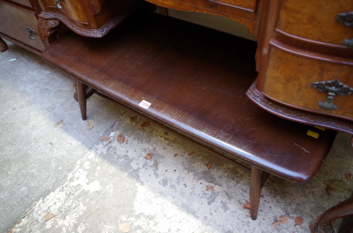 An Ercol dark wood low occassional table, 104cm wide.