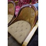 A pair of 19th century beechwood and cane tub chairs, on brass castors.