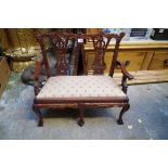 A reproduction carved mahogany miniature chair back settee, in the Georgian style, 59cm wide.