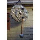 A Chinese cast brass gong, relief decorated with dragons, 45cm diameter.