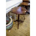 An old walnut octagonal tripod table, 40cm diameter; together with a similar mahogany example.