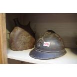 A French World War I M15 Adrian helmet; together with a similar metal bottle. (2)