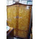 A reproduction burr walnut bedroom suite, comprising a double wardrobe; a four drawer chest; a