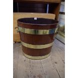 A Georgian mahogany and brass bound twin handled peat bucket, with lead liner, 42cm high.