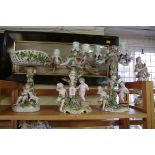 Two similar Continental porcelain figural candelabra, largest 36cm high; together with another