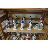 A collection of nine Continental porcelain military figures.