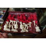 An antique bone chess set, red stained and natural, king 8.4cm, pawn 3.3cm.